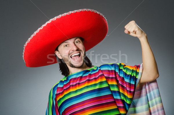 Man in a vivid mexican poncho gray background isolated Stock photo © Elnur