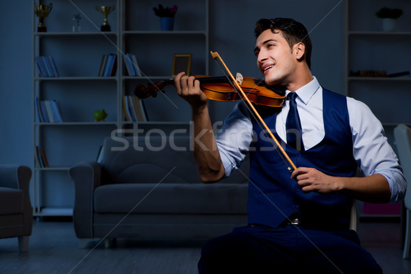 Young musician man practicing playing violin at home Stock photo © Elnur