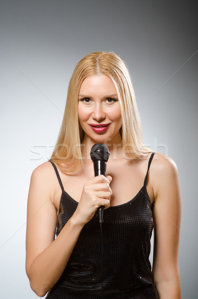 Stock photo: Woman singing in karaoke club