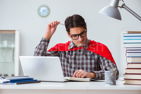 Super hero student with books studying for exams Stock photo © Elnur