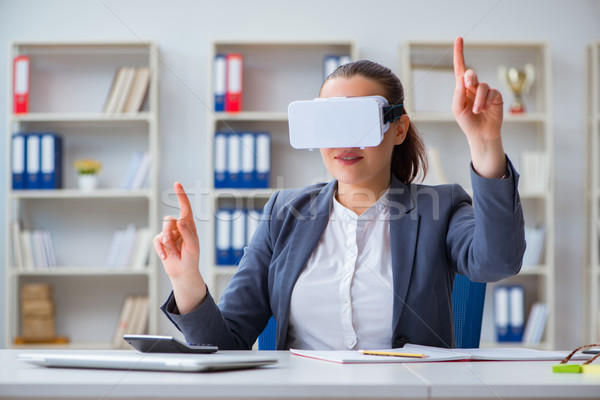 Businesswoman with virtual reality glasses in office Stock photo © Elnur