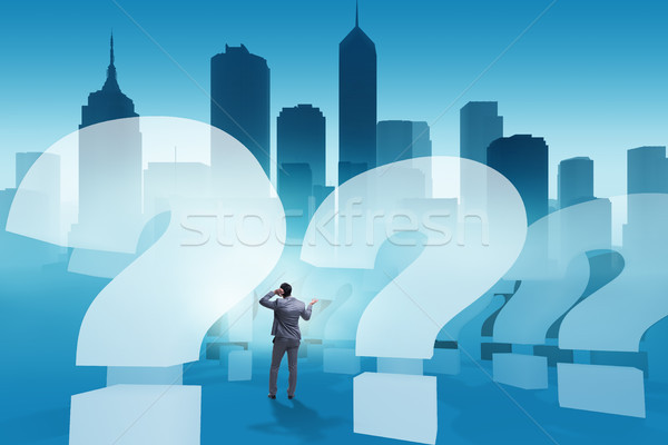 Businessman in uncertainty concept with question marks Stock photo © Elnur