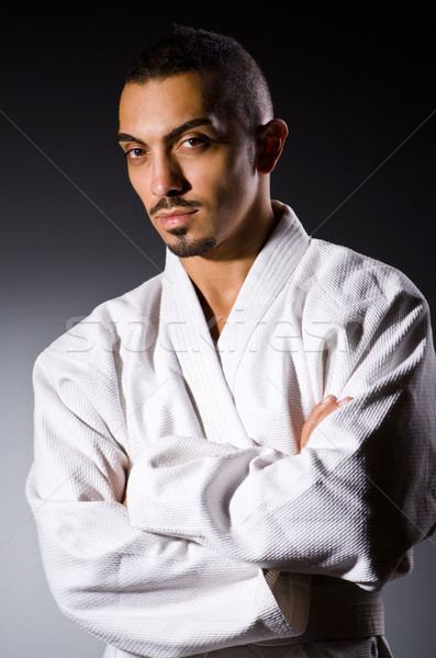 Stock photo: Karate player in dark room