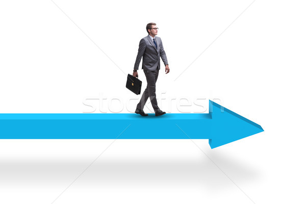Stock photo: Businessman walking on arrow in business concept