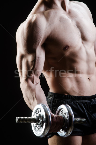 Muscular ripped bodybuilder with dumbbells Stock photo © Elnur