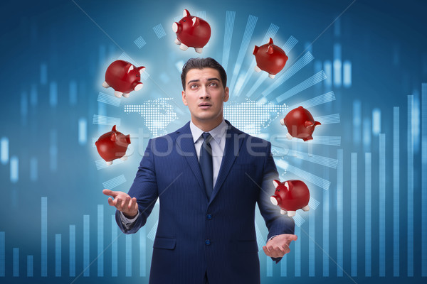 Businessman juggling with piggybanks in business concept Stock photo © Elnur