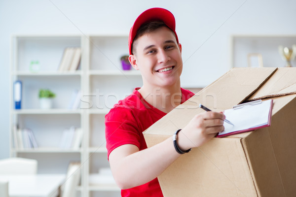 Post man delivering a parcel package Stock photo © Elnur
