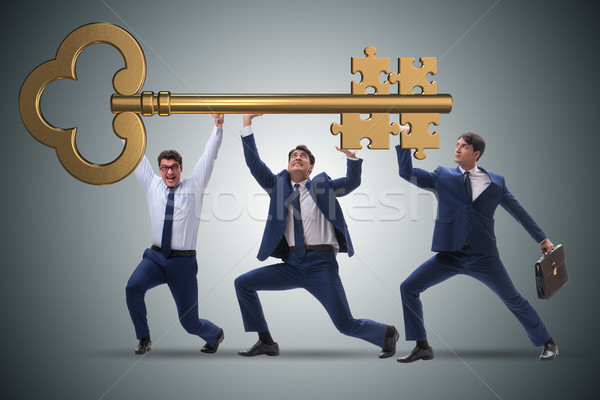 Businessmen holding giant key in business concept Stock photo © Elnur