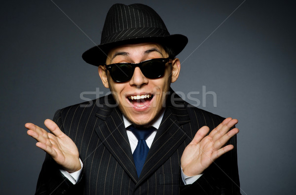 Young man in elegant suit against gray Stock photo © Elnur