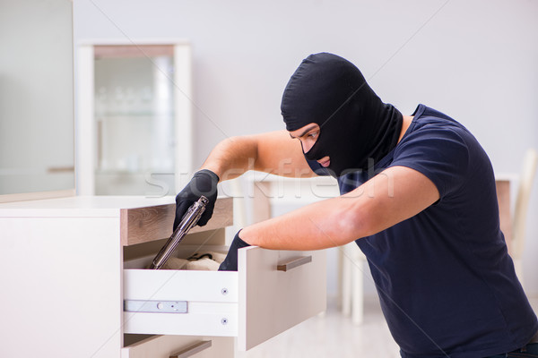 Robber wearing balaclava stealing valuable things Stock photo © Elnur