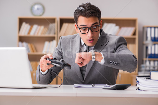 Businessman playing computer games at work office Stock photo © Elnur