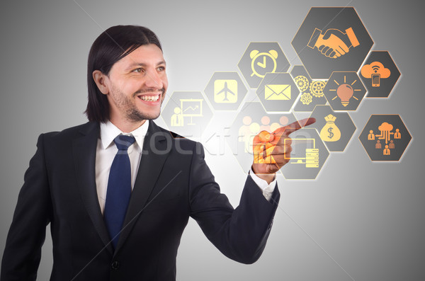 Businessman pressing virtual buttons in business concept Stock photo © Elnur