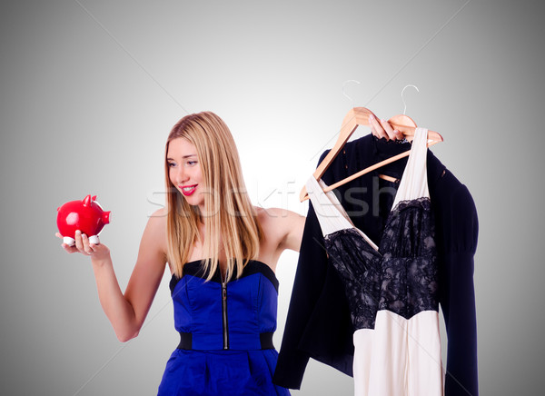 Woman thinking of spending her savings on clothing Stock photo © Elnur