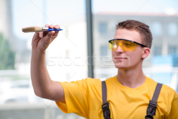 Young construction worker in yellow coveralls Stock photo © Elnur