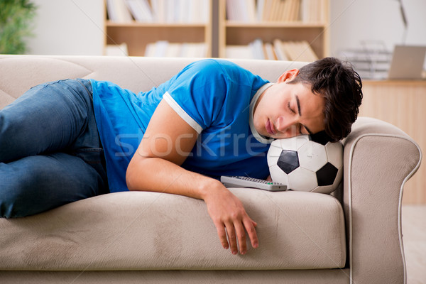 Man watching football at home sitting in couch Stock photo © Elnur
