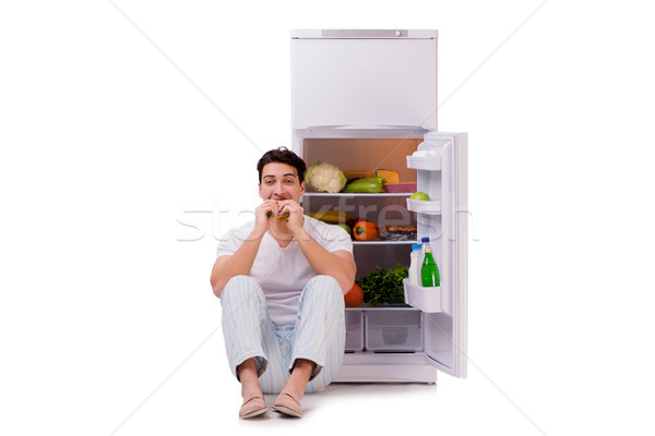Stock photo: Man next to fridge full of food