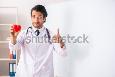 Cardiologist with red heart in medical concept Stock photo © Elnur