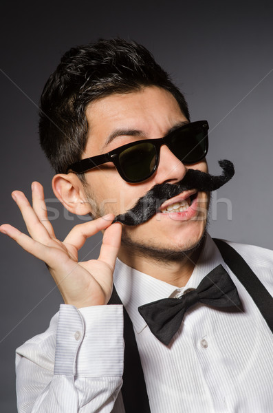 Młody człowiek fałszywy wąsy odizolowany szary moda Zdjęcia stock © Elnur