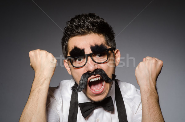 [[stock_photo]]: Jeune · homme · faux · moustache · isolé · gris · modèle