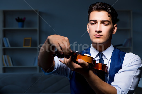 Young musician man practicing playing violin at home Stock photo © Elnur