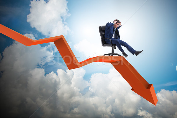 Stock photo: The businessman sliding down on chair in economic crisis concept