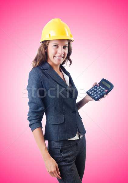 Female builder with calculator against gradient  Stock photo © Elnur