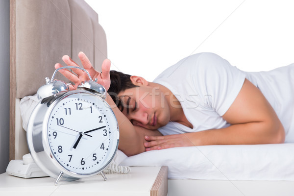 Człowiek bed cierpienie bezsenność zegar zdrowia Zdjęcia stock © Elnur