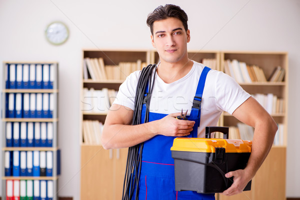 Stock photo: Man doing electrical repairs at home