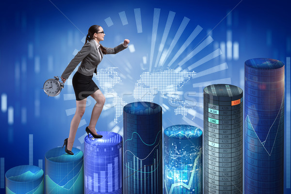Businesswoman rushing with clock on bar charts Stock photo © Elnur