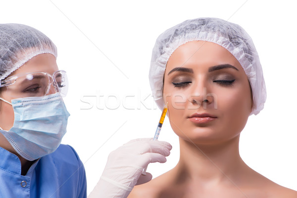 Młoda kobieta wstrzykiwań botox odizolowany biały kobieta Zdjęcia stock © Elnur