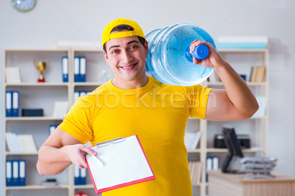 The man delivering water bottle to the office Stock photo © Elnur