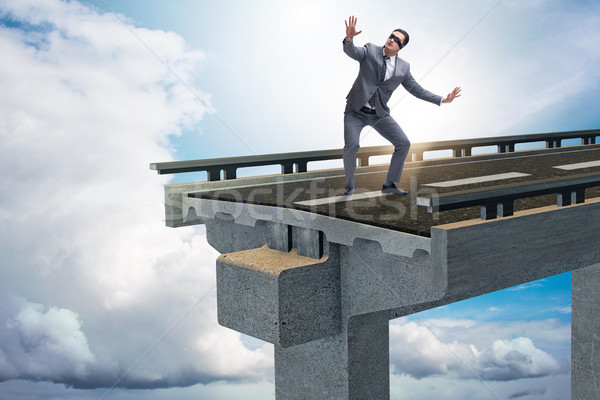 Stock photo: Businessman in uncertainty concept with broken bridge