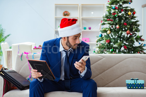 Businessman working at home during christmas Stock photo © Elnur