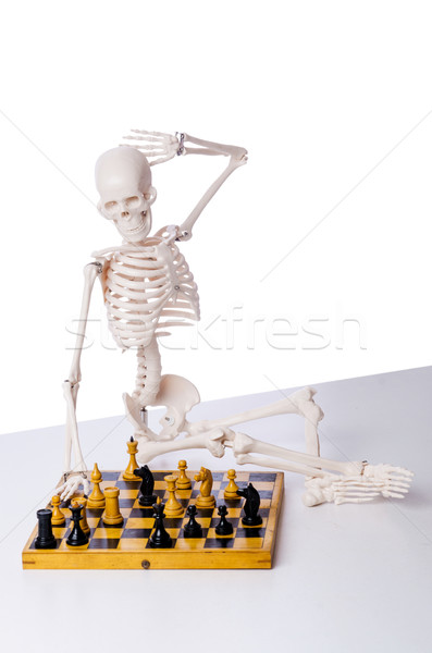 Skeleton playing chess game on white Stock photo © Elnur