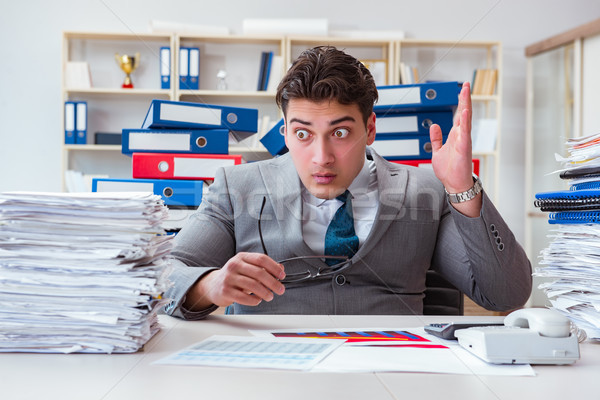 Businessman busy with much paperwork Stock photo © Elnur