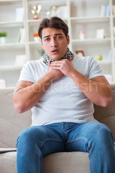 Young man suffering from sore throat Stock photo © Elnur