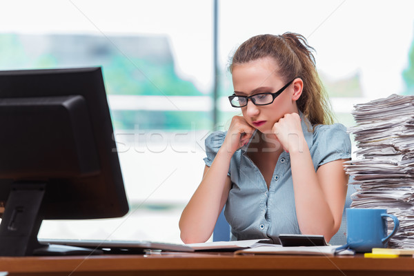 The stressed businesswoman with stack of papers Stock photo © Elnur