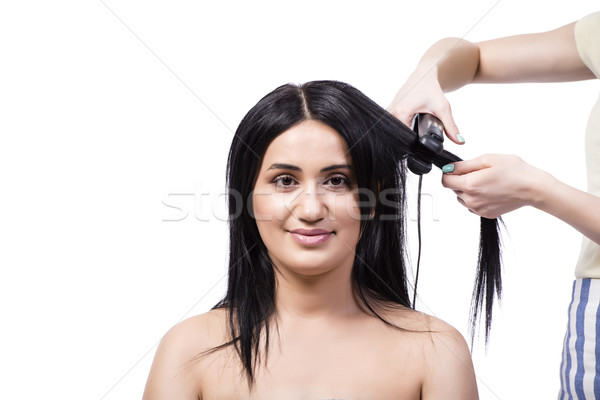 Young woman getting hair straightner isolated on white Stock photo © Elnur
