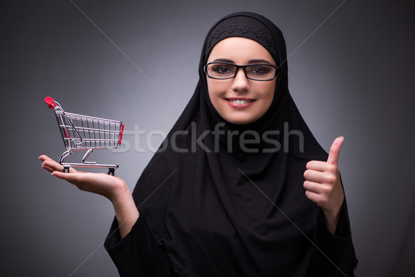 The muslim woman in black dress against dark background Stock photo © Elnur