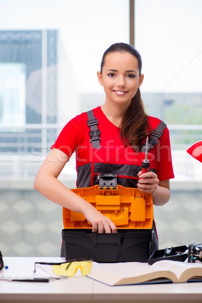 Young woman in coveralls doing repairs Stock photo © Elnur