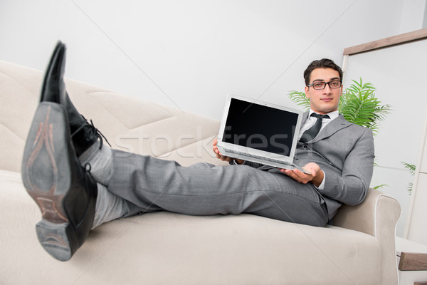 Fiatal üzletember kanapé számítógép munka diák Stock fotó © Elnur