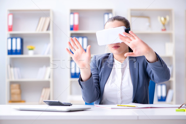 Businesswoman with virtual reality glasses in office Stock photo © Elnur
