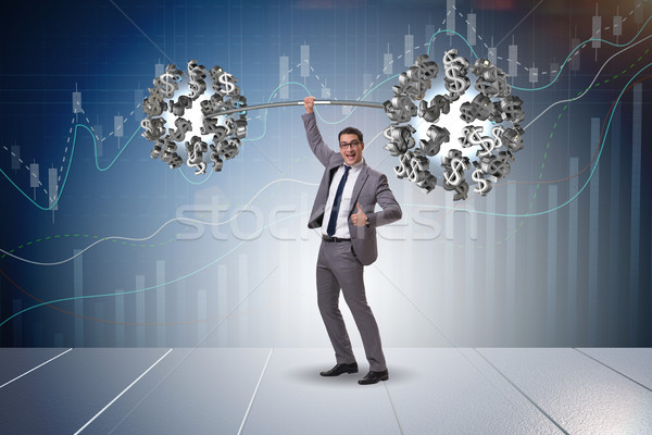 Businessman lifting barbell with dollars Stock photo © Elnur