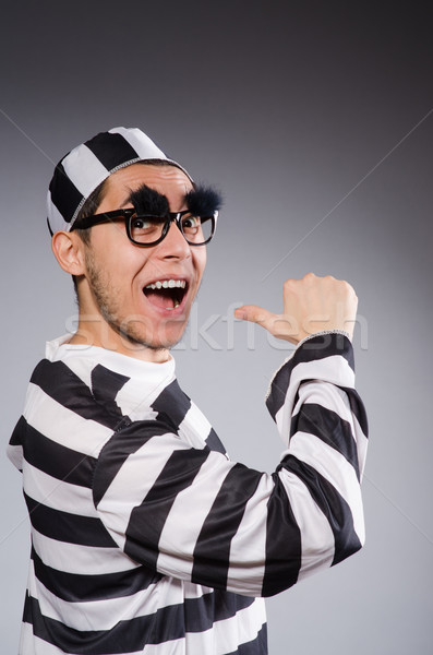 Stock photo: Young prisoner against gray