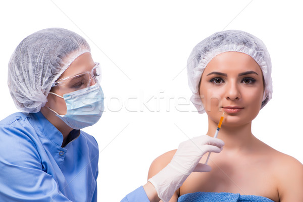 Young woman preparing for injection of botox isolated on white Stock photo © Elnur