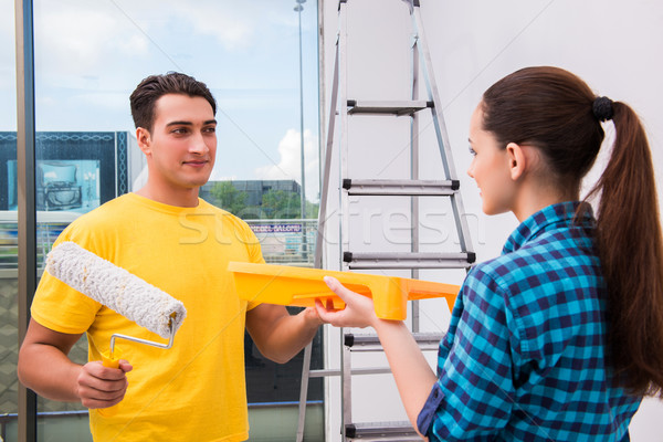 Stock photo: Young couple painting wall at home