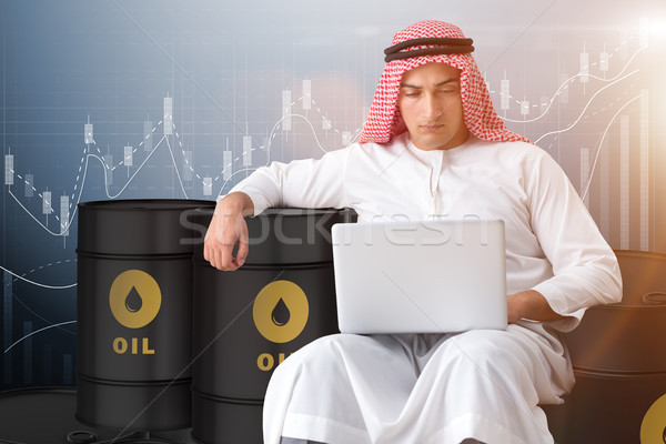 The arab businessman trading crude oil on laptop Stock photo © Elnur