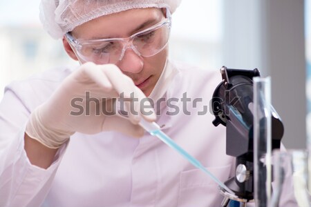 Young doctor working on blood test in lab hospital Stock photo © Elnur