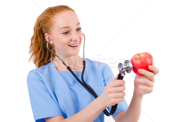 Pretty doctor  in blue uniform  with stetothcope and apple isola Stock photo © Elnur