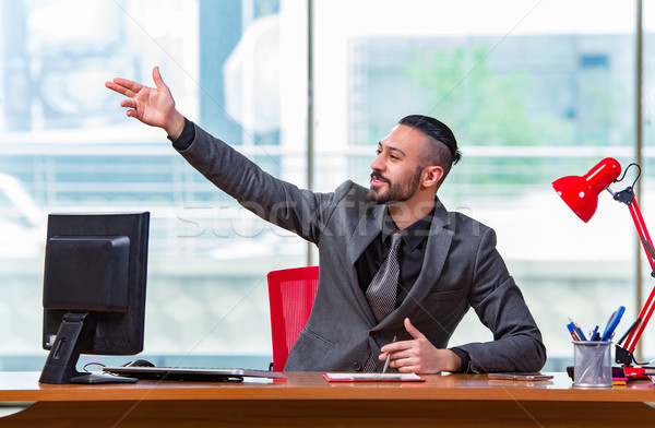 Businessman cheering saluting in the office Stock photo © Elnur